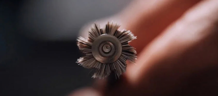Close‑up of dental restoration surface being refined with DiaShine brushes and RA Latch chamois wheel during final polish